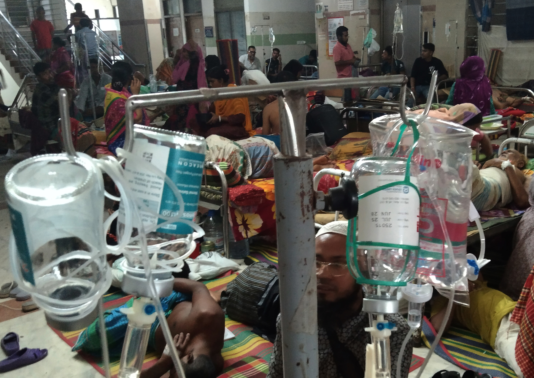 Patients suffering from high fever lie on the hospital floor due to a lack of available beds, as cases of a mysterious viral illness surge across the country. The photo was taken at Dhaka Medical College Hospital on Sunday, August 11. Photo: Ali Hossain Mintu.